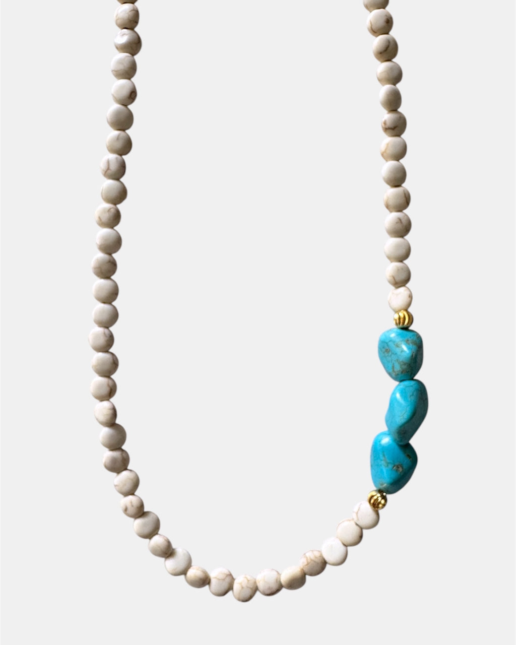 Beige necklace featuring turquoise stones for a natural, earthy style