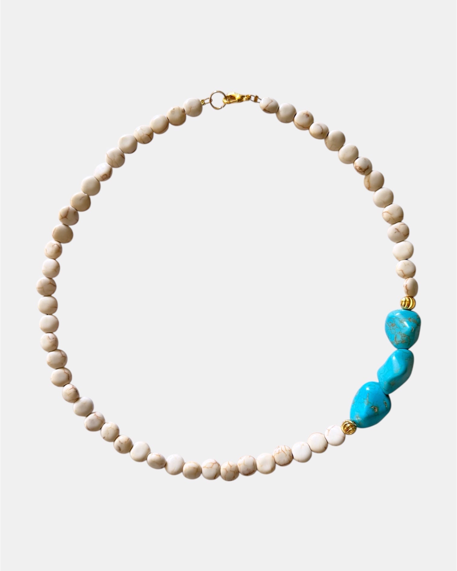 Beige necklace featuring turquoise stones for a natural, earthy style
