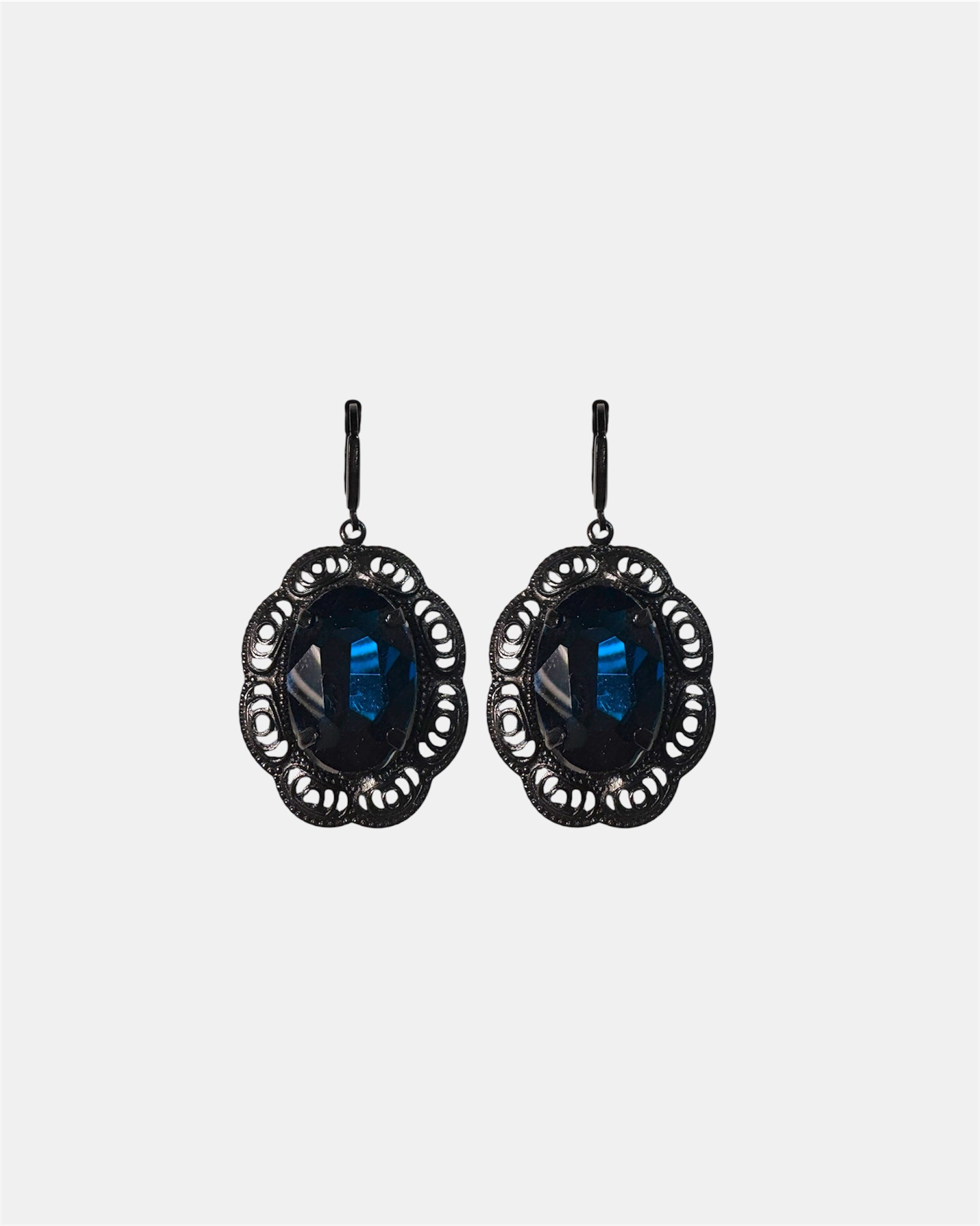 Black dangling earrings featuring a blue gemstone, elegant jewelry design on a plain background.