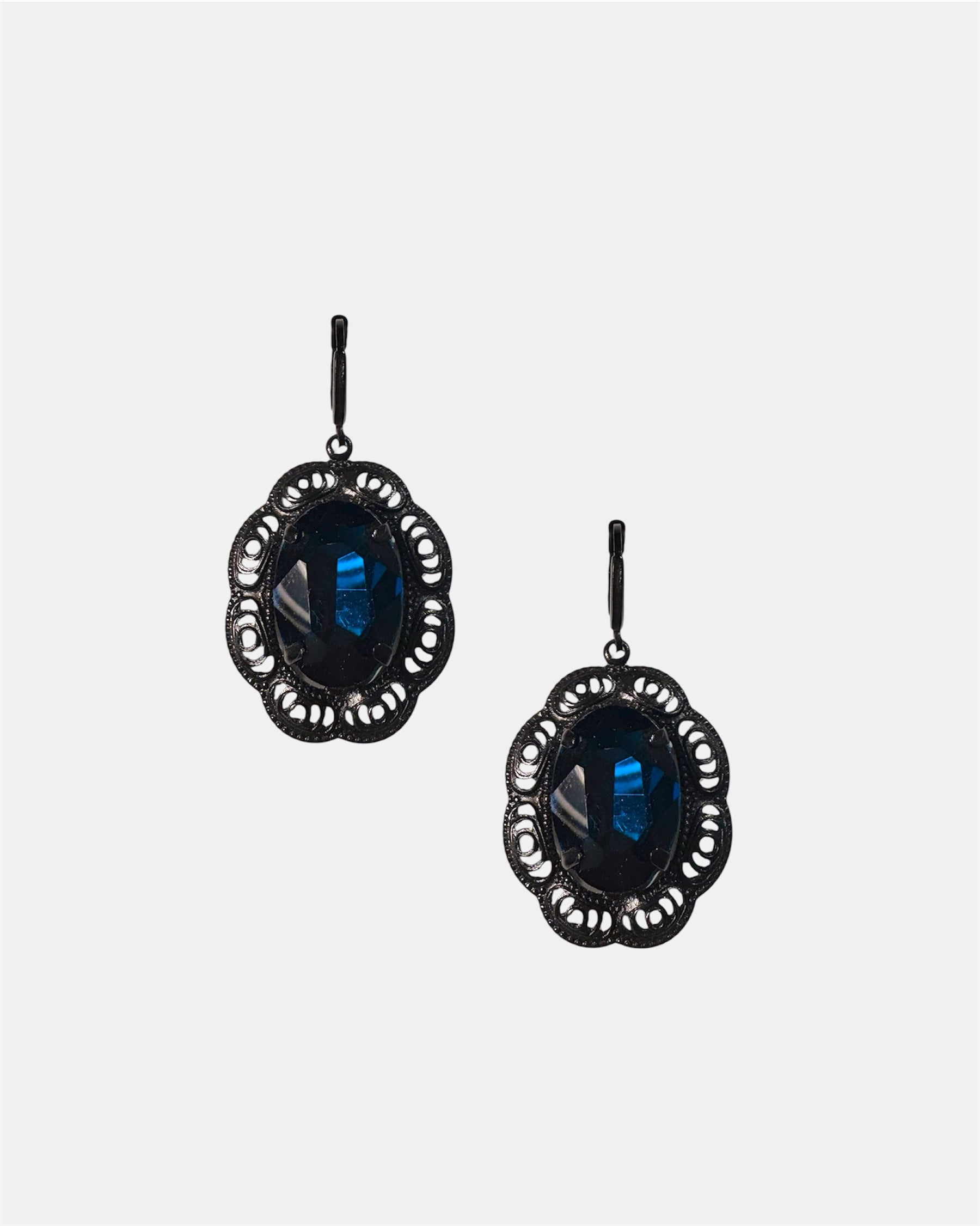 Black dangling earrings featuring a blue gemstone, elegant jewelry design on a plain background.