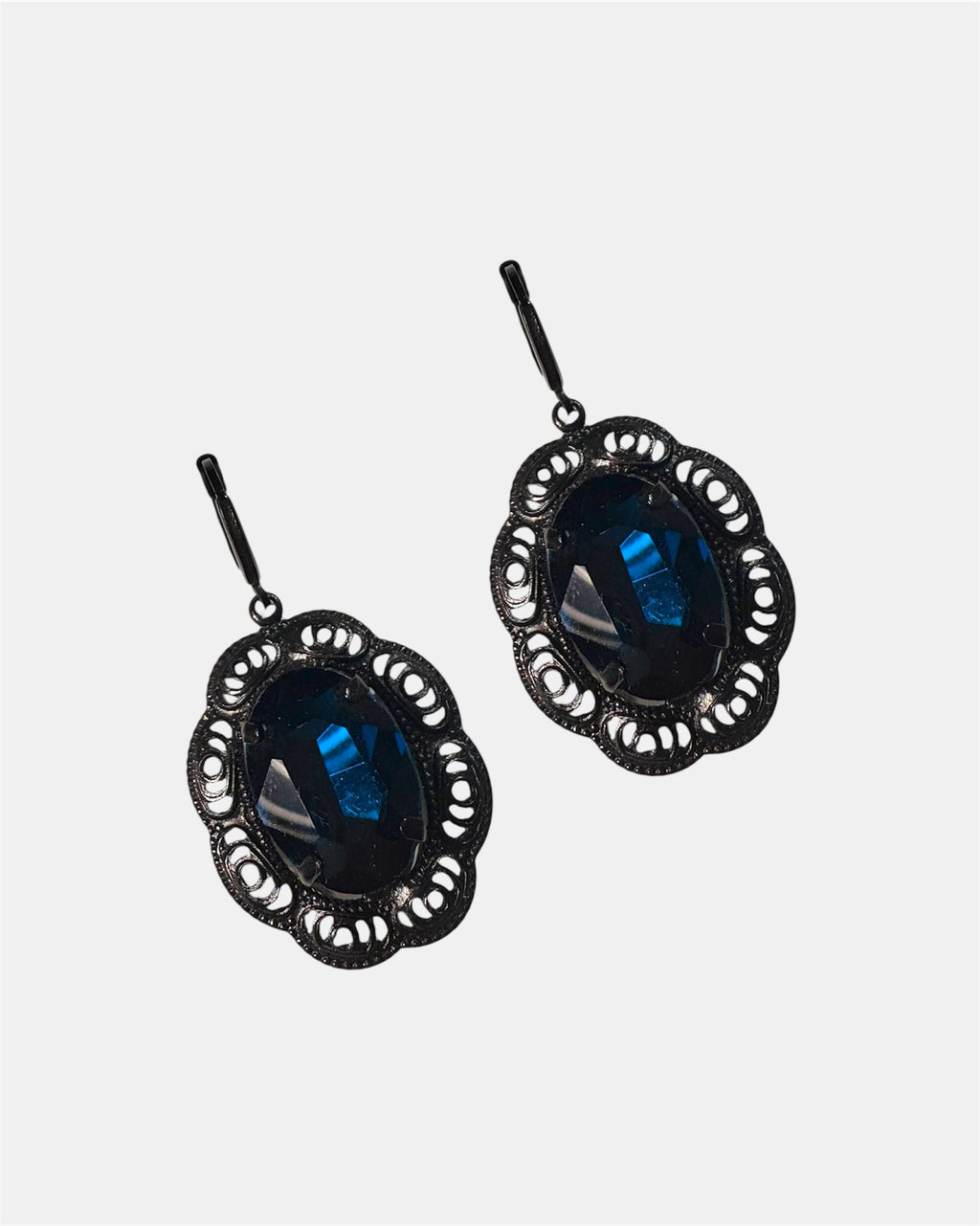 Black dangling earrings featuring a blue gemstone, elegant jewelry design on a plain background.