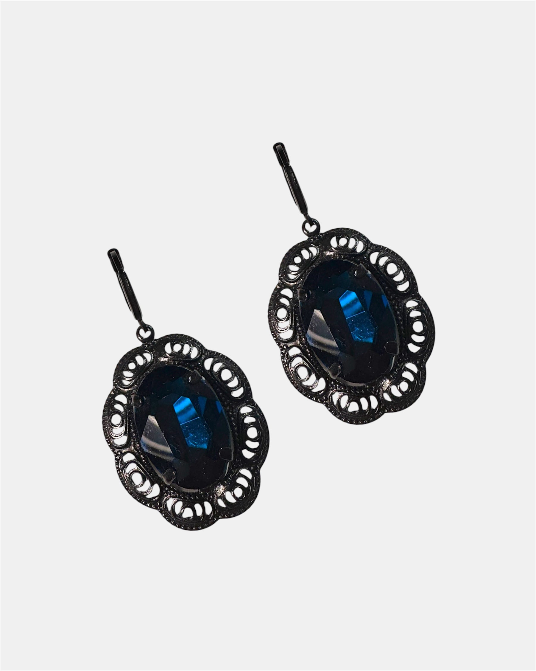 Black dangling earrings featuring a blue gemstone, elegant jewelry design on a plain background.