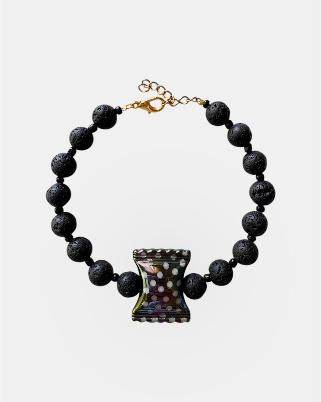 Black lava bead bracelet with a ceramic candy charm