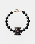 Black lava bead bracelet with a ceramic candy charm