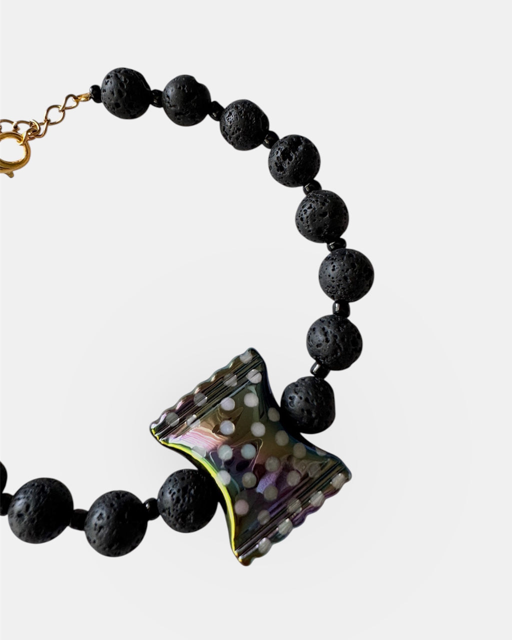 Black lava bead bracelet with a ceramic candy charm