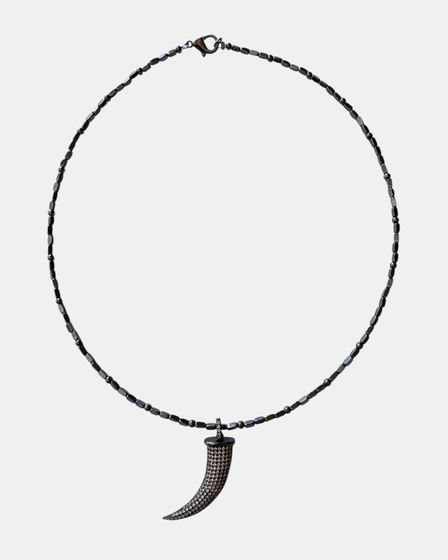 Black necklace with a horn pendant
