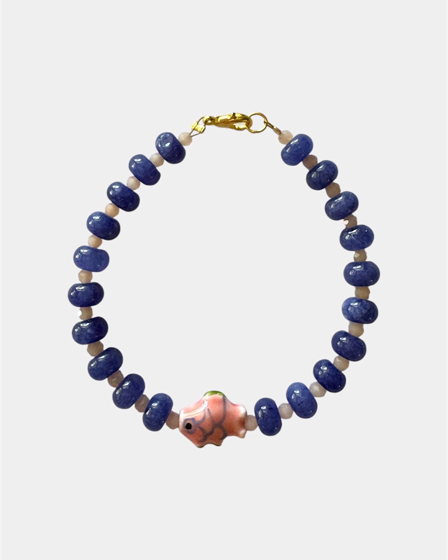 Blue beaded bracelet with fish charm in nautical elegant style