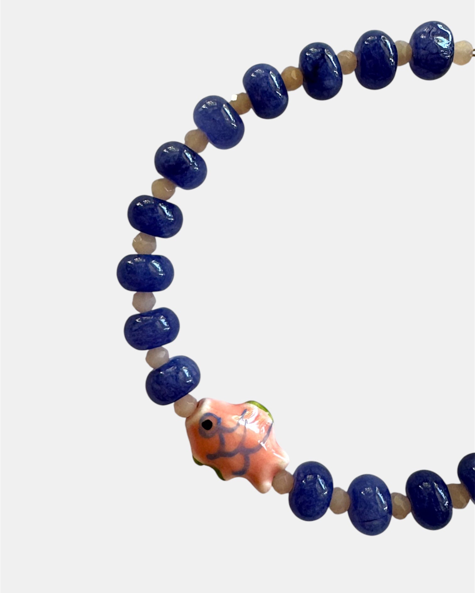 Blue beaded bracelet with fish charm in nautical elegant style