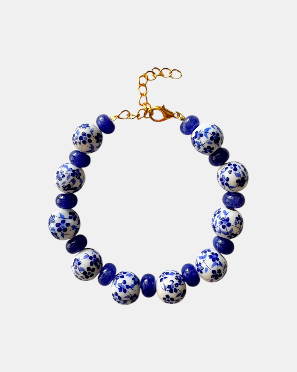 Bracelet with blue and white patterned beads on a light gray background
