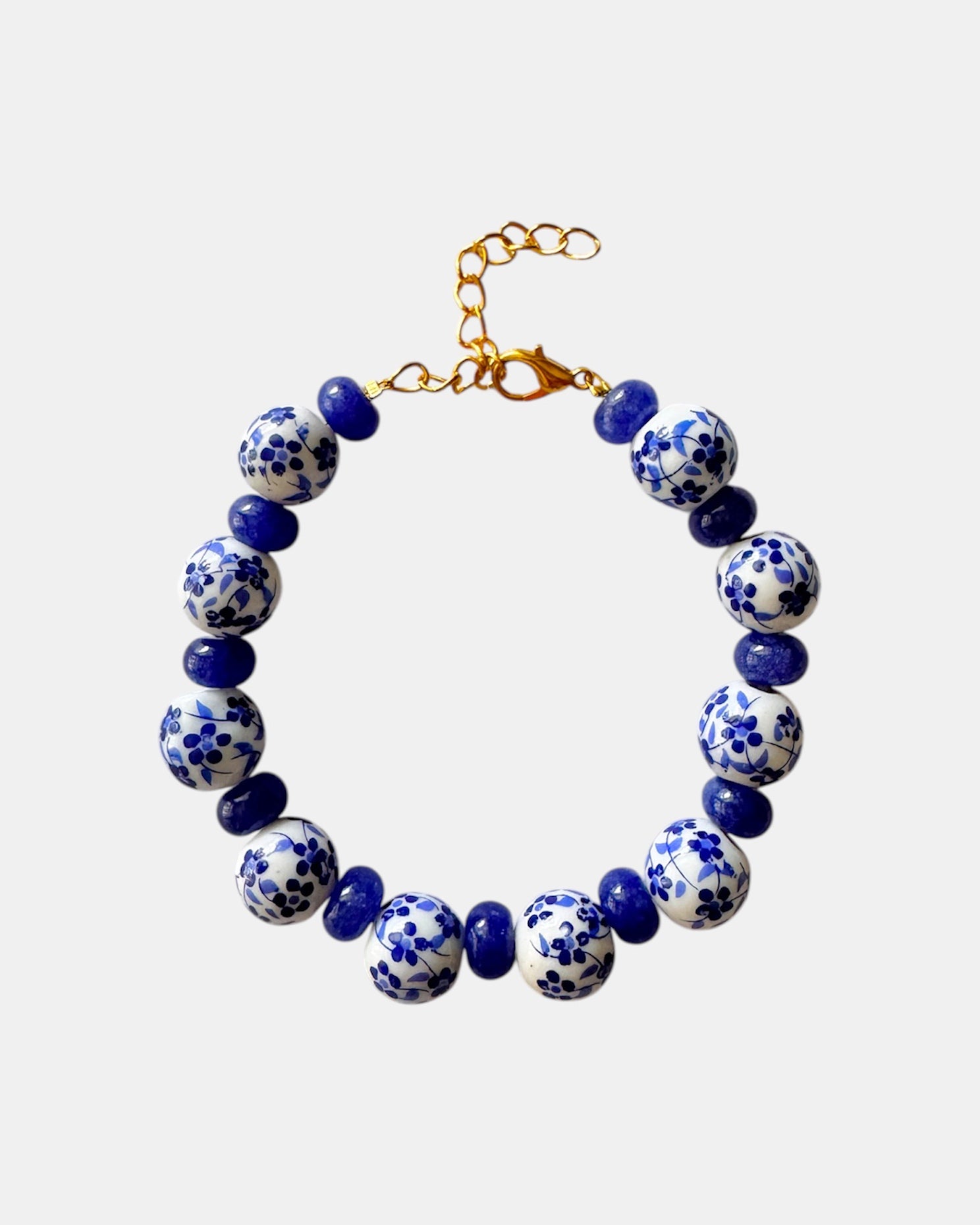 Bracelet with blue and white patterned beads on a light gray background