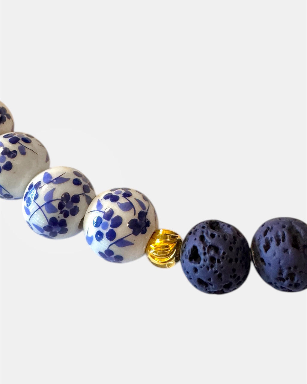 Blue necklace featuring lava beads and ceramic beads for a unique and textured style