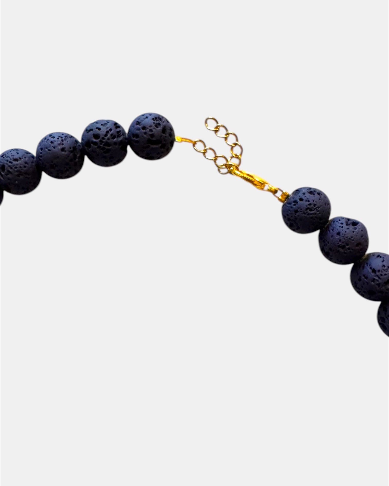 Blue necklace featuring lava beads and ceramic beads for a unique and textured style