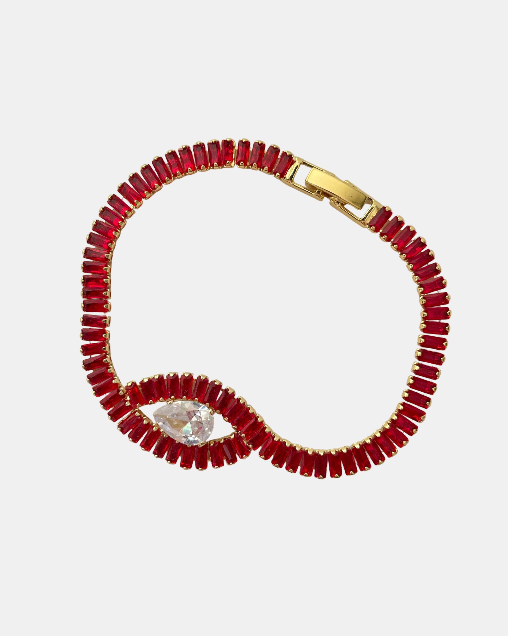 Χρυσό βραχιόλι με ζιργκόν και κεντρικό κόκκινο στοιχείο σε σχήμα ματιού.