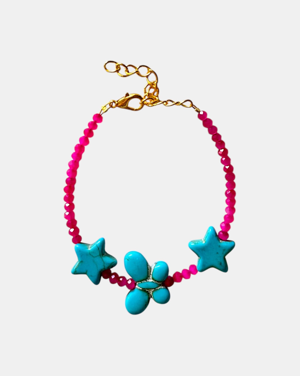 Fuchsia bracelet decorated with turquoise star charms and a butterfly for a whimsical, playful style