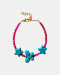 Fuchsia bracelet decorated with turquoise star charms and a butterfly for a whimsical, playful style