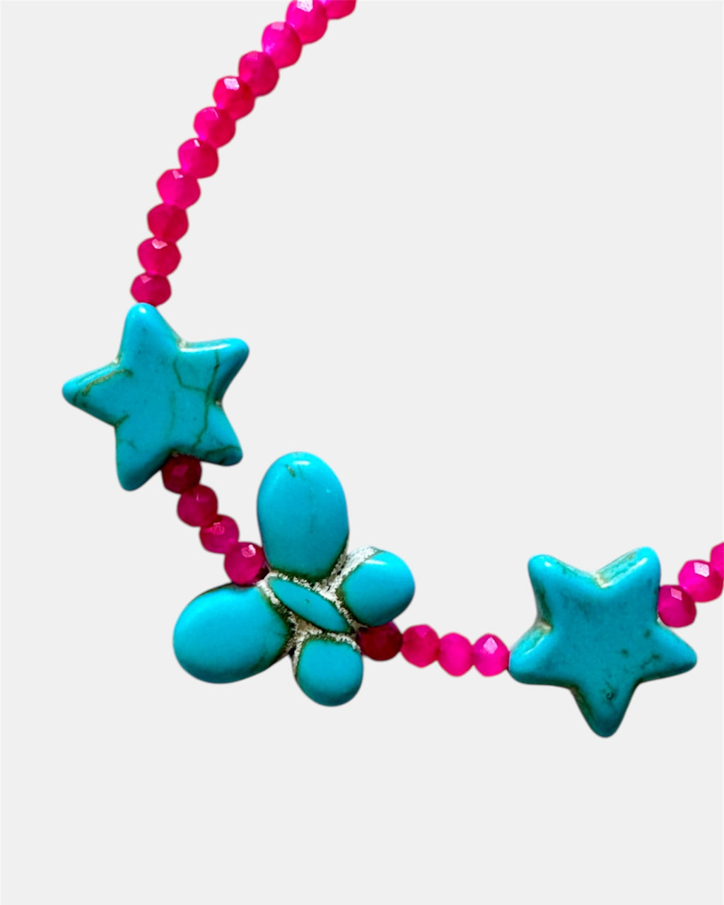 Fuchsia bracelet decorated with turquoise star charms and a butterfly for a whimsical, playful style
