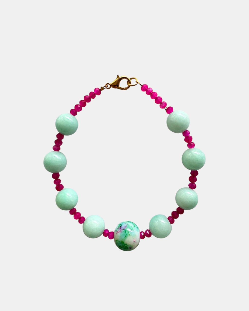 Gold bracelet with mint and fuchsia beads.