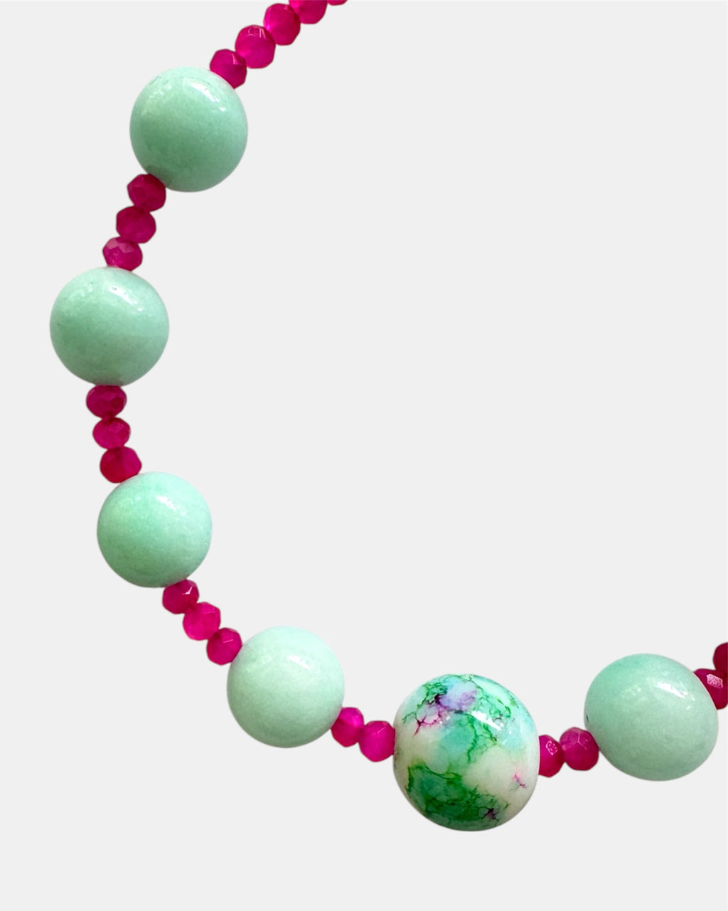 Gold bracelet with mint and fuchsia beads.