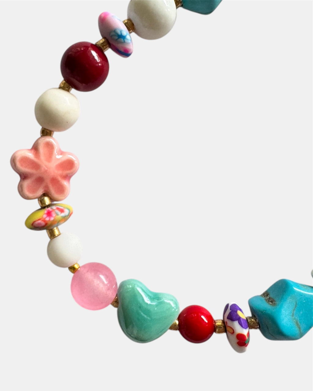 Gold bracelet featuring multiple multicolored beads arranged along a fine chain, creating a vibrant and elegant jewelry design.