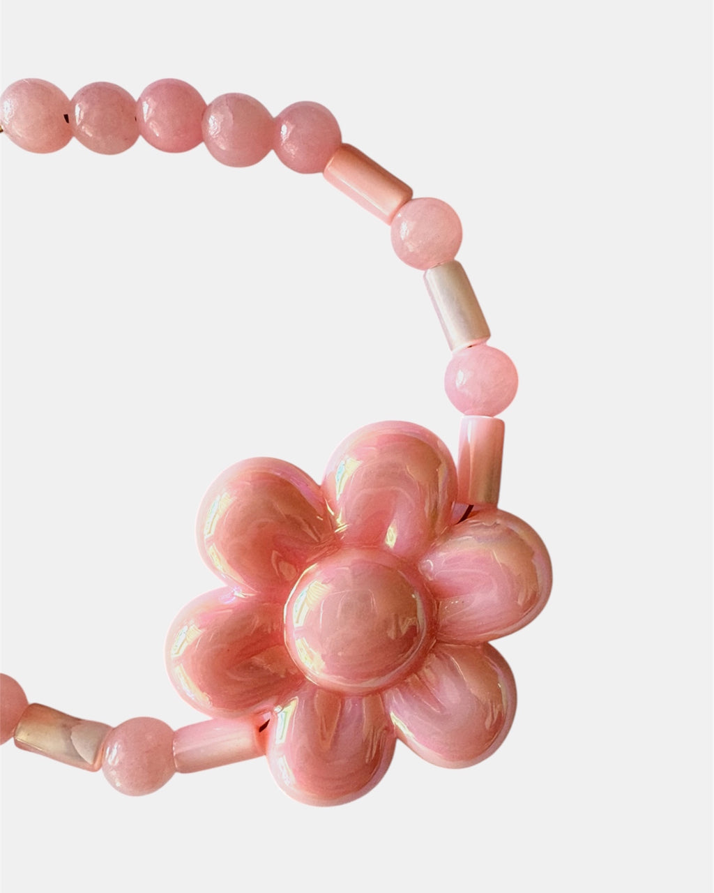 Gold bracelet with pink beads and a ceramic flower charm