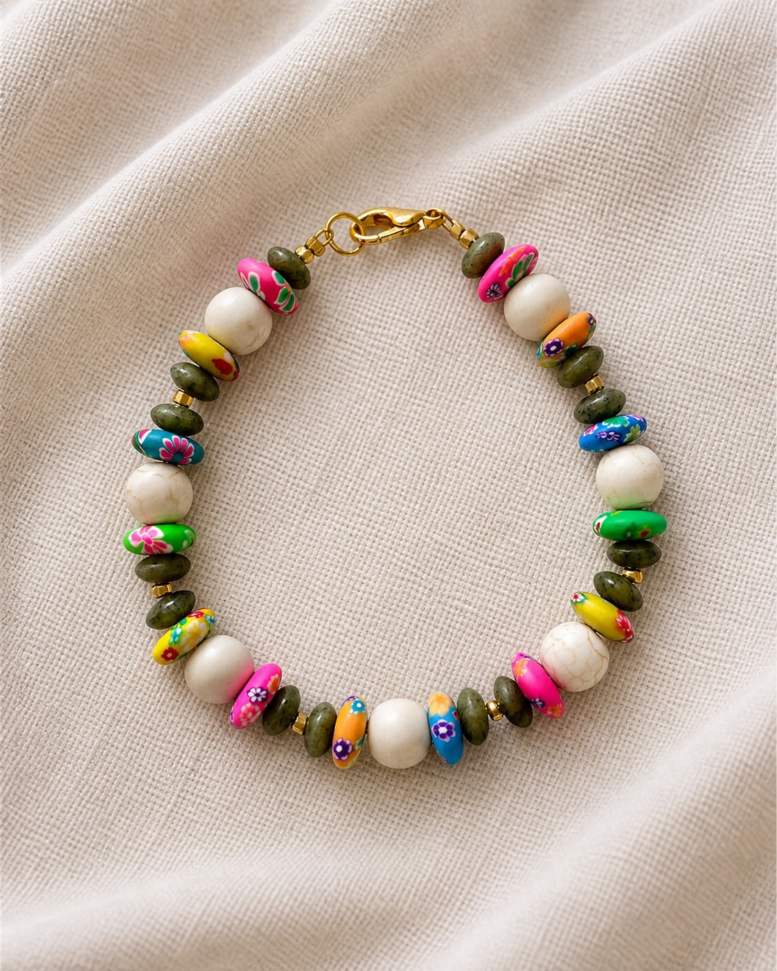 Gold bracelet with ecru and multicolor beads in vibrant boho style