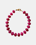 Gold bracelet with fuchsia beads in vibrant elegant style