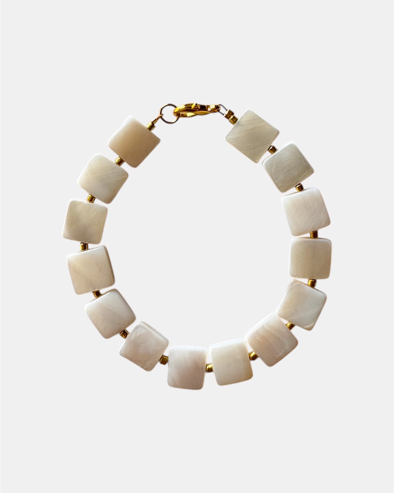 Necklace with square beige beads on a white background