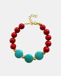 Gold bracelet with red and turquoise beads in colorful elegant style