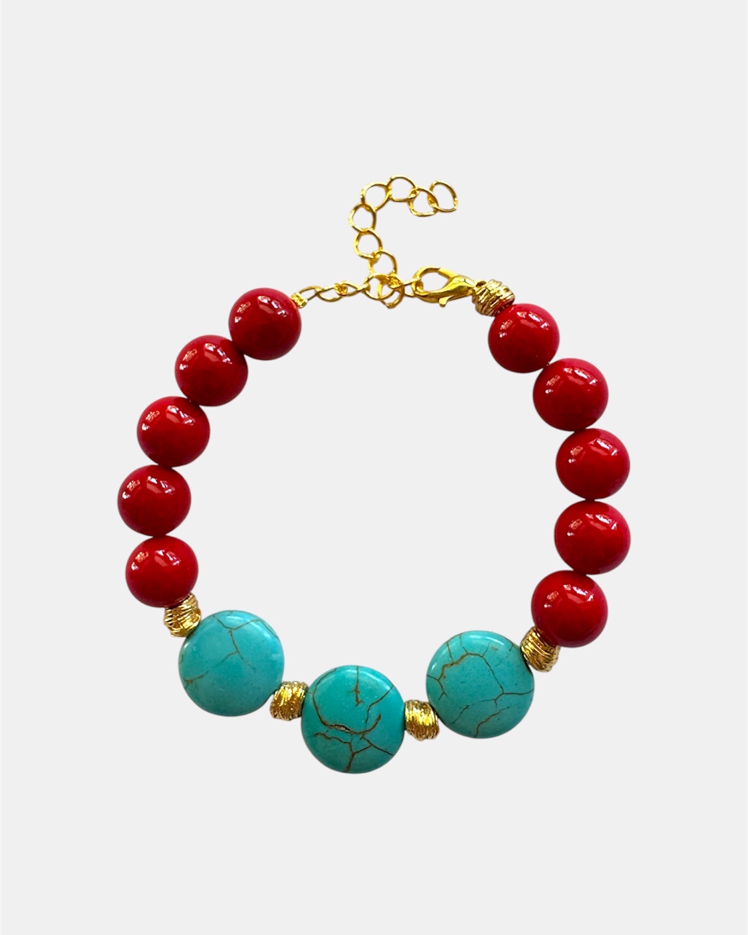 Gold bracelet with red and turquoise beads in colorful elegant style