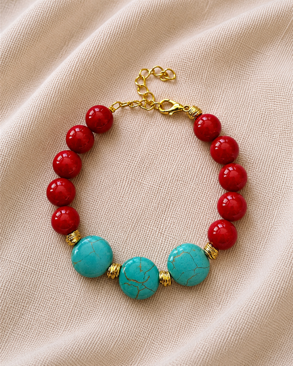 Gold bracelet with red and turquoise beads in colorful elegant style