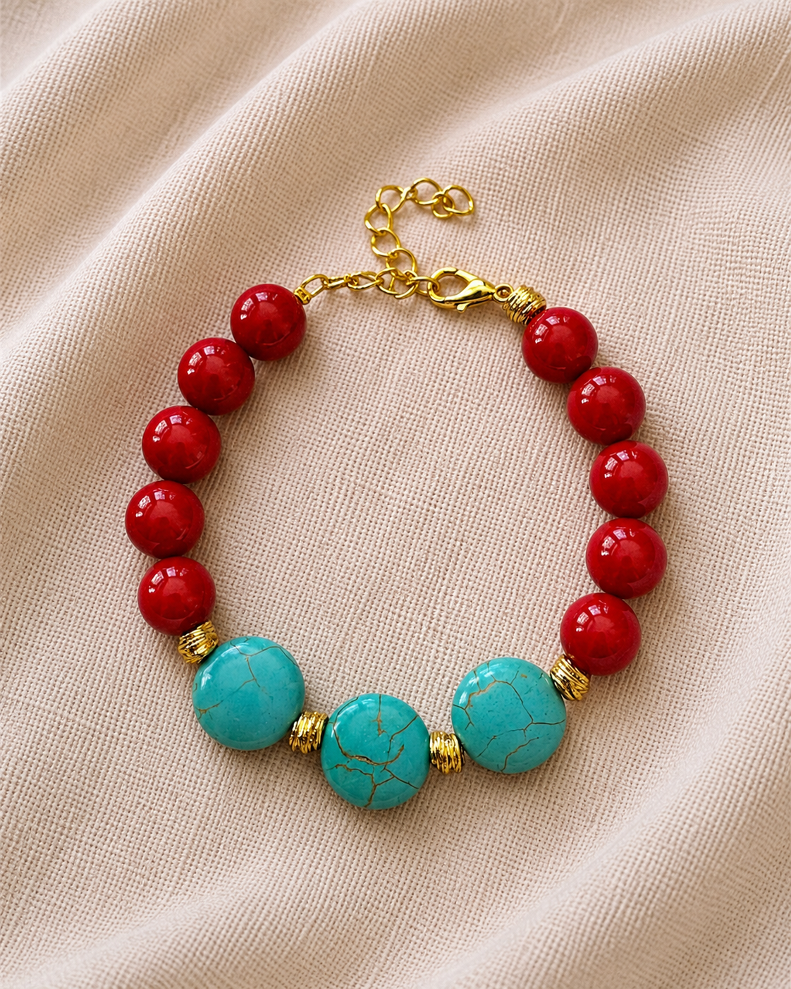 Gold bracelet with red and turquoise beads in colorful elegant style