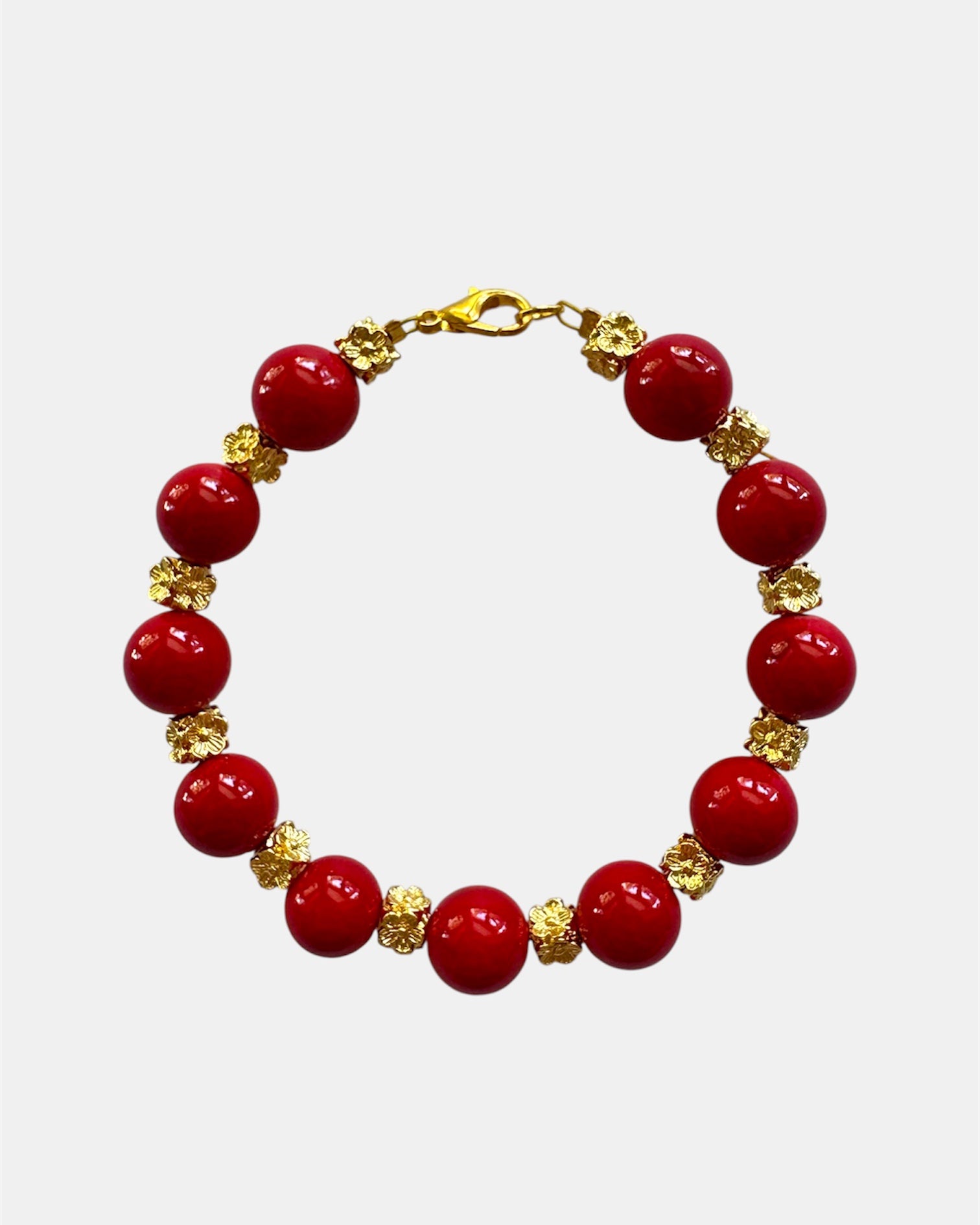 Gold bracelet with red beads in elegant minimalist style