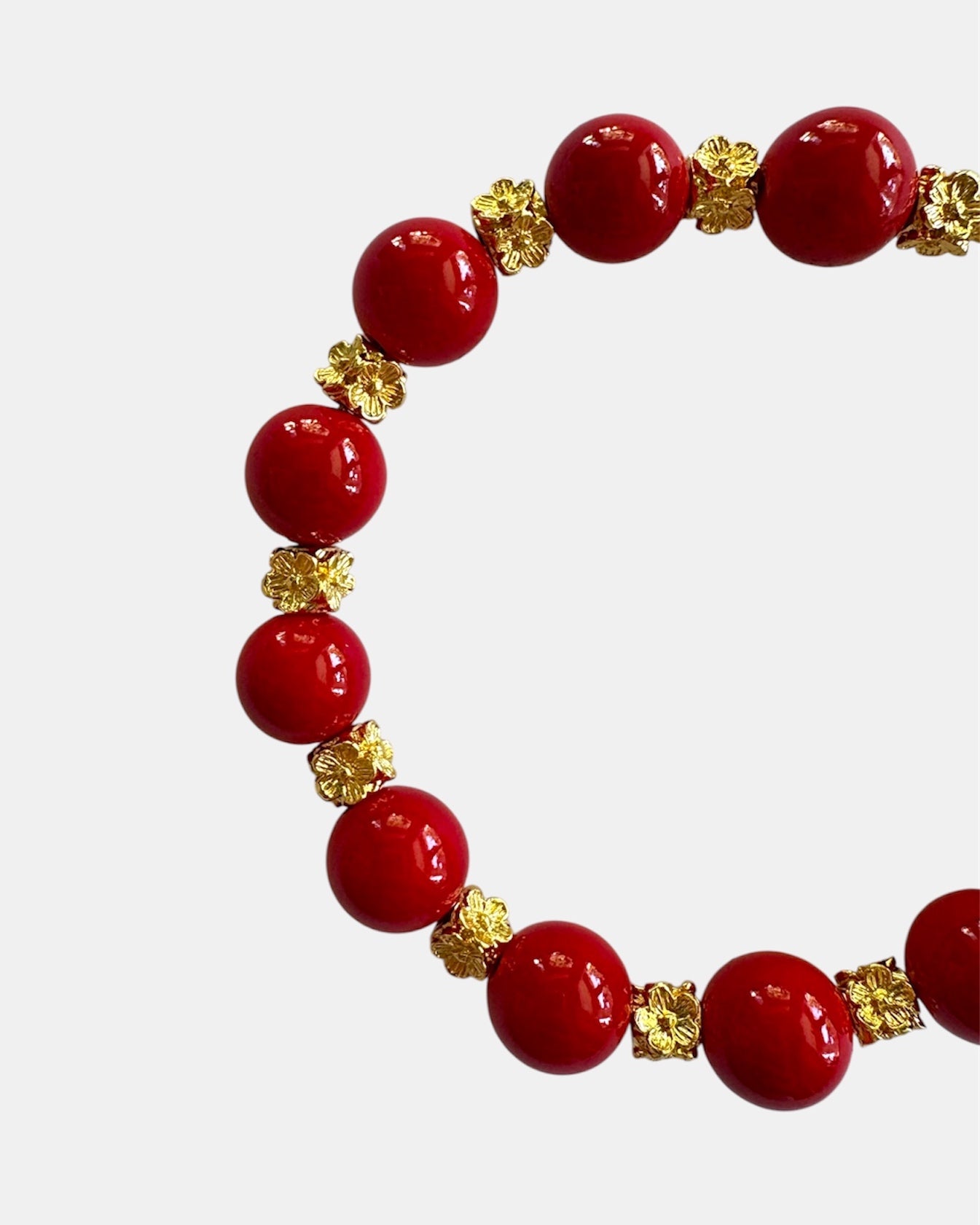 Gold bracelet with red beads in elegant minimalist style