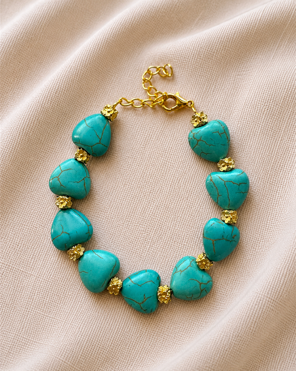 Gold bracelet with turquoise beads and heart charm in elegant boho style