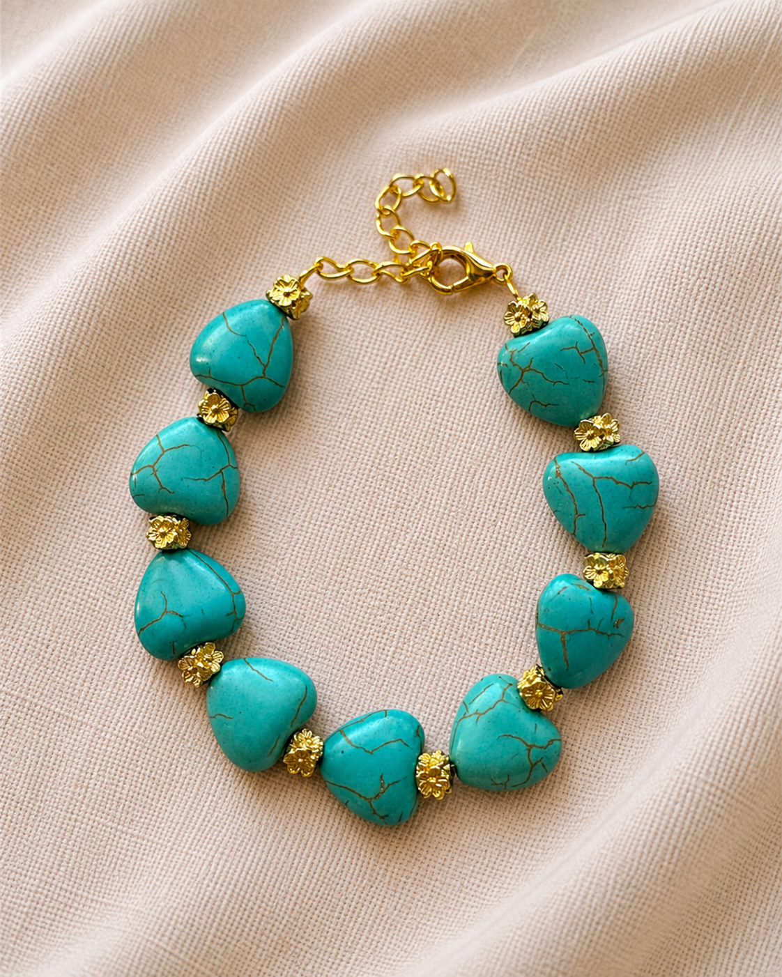 Gold bracelet with turquoise beads and heart charm in elegant boho style