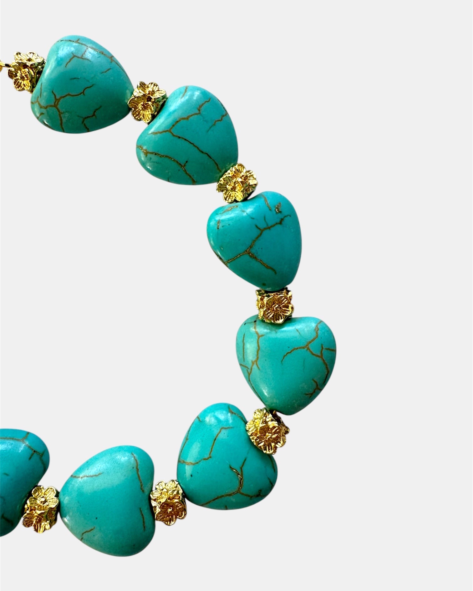 Gold bracelet with turquoise beads and heart charm in elegant boho style