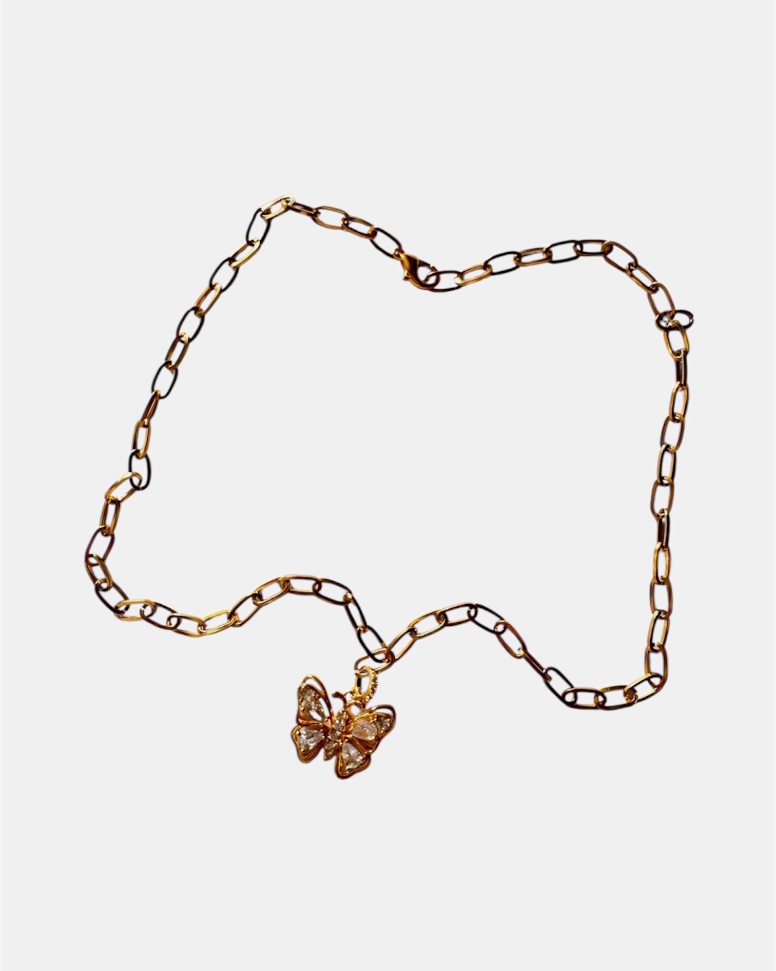 Gold necklace with a butterfly and crystal details