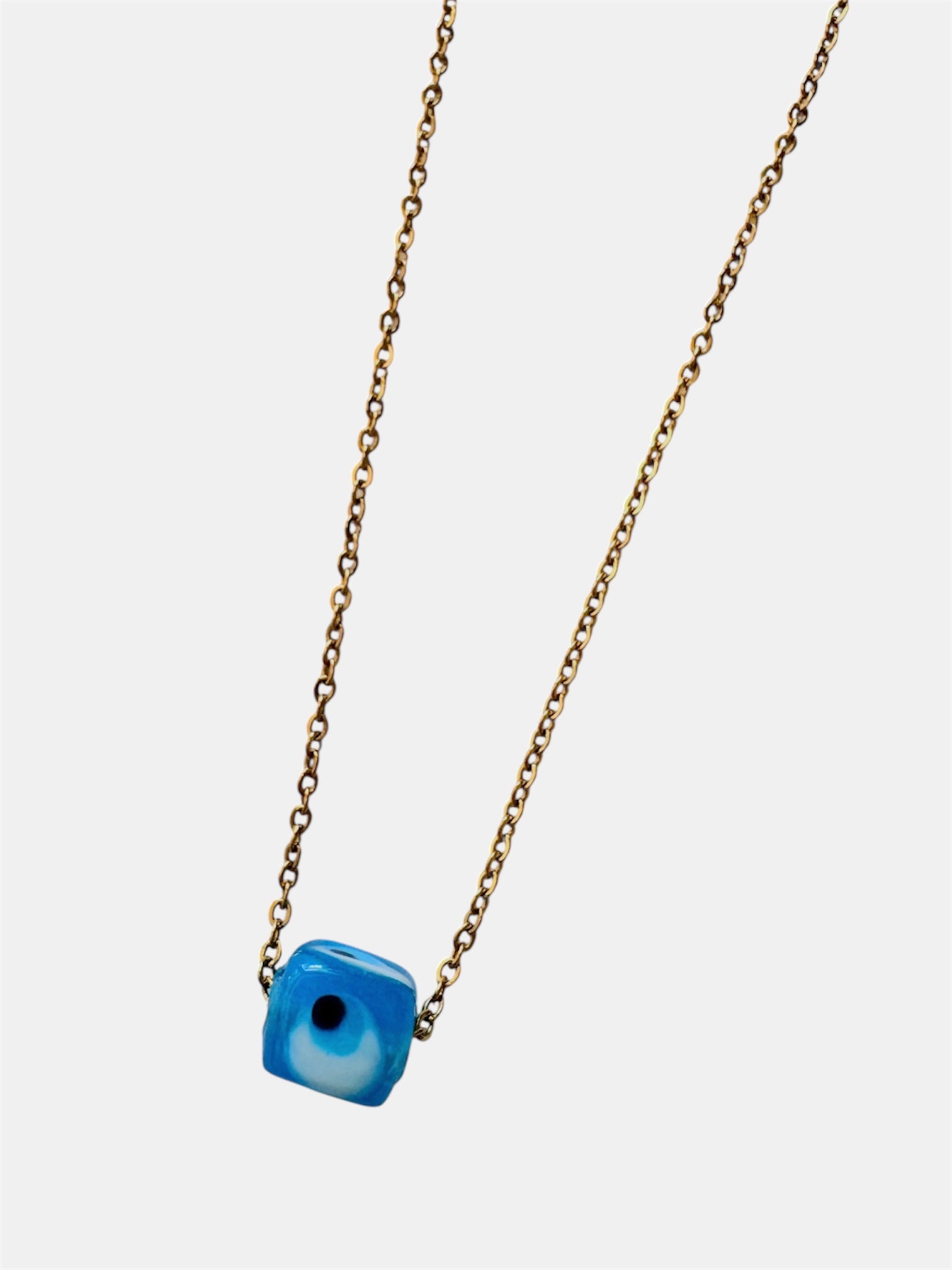 Gold chain necklace with a blue glass evil eye charm