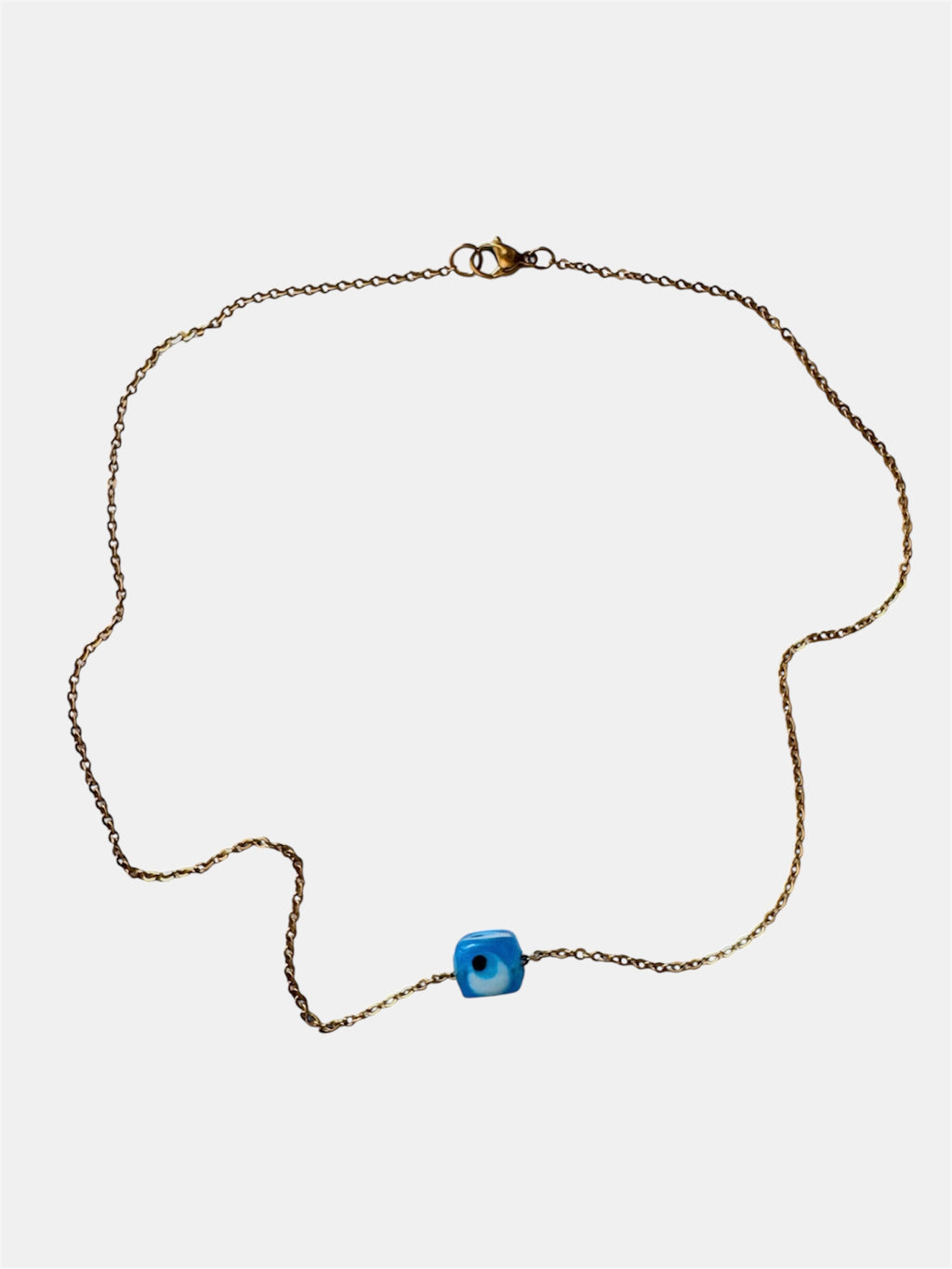 Gold chain necklace with a blue glass evil eye charm