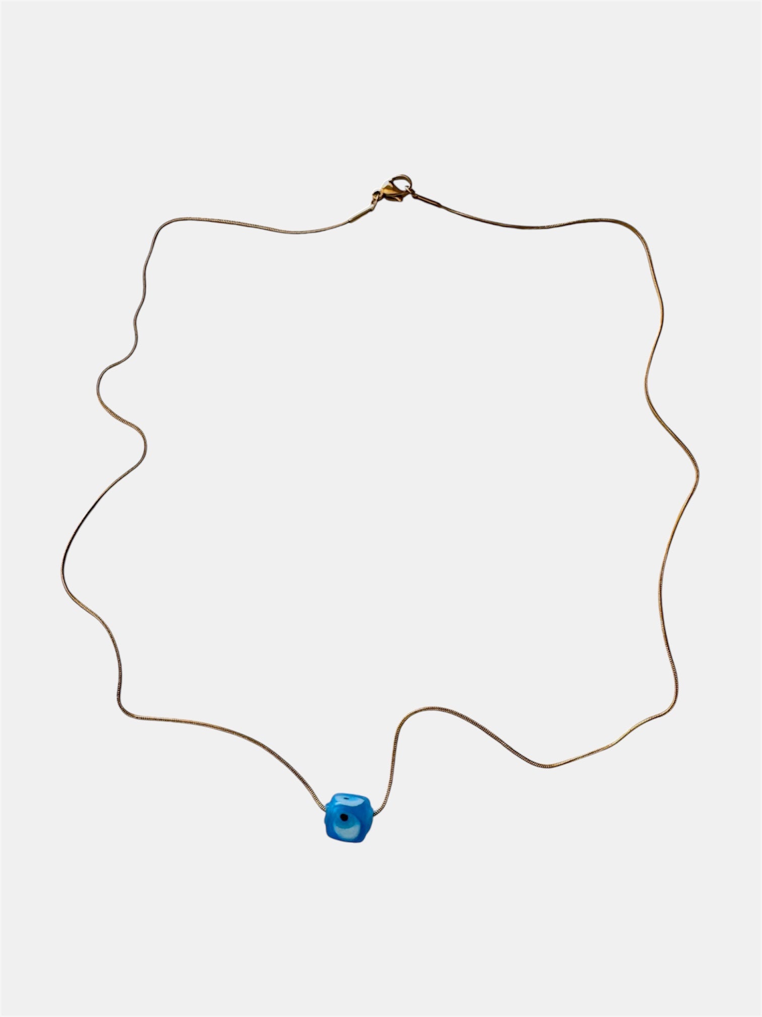 Gold chain necklace with a blue glass evil eye charm