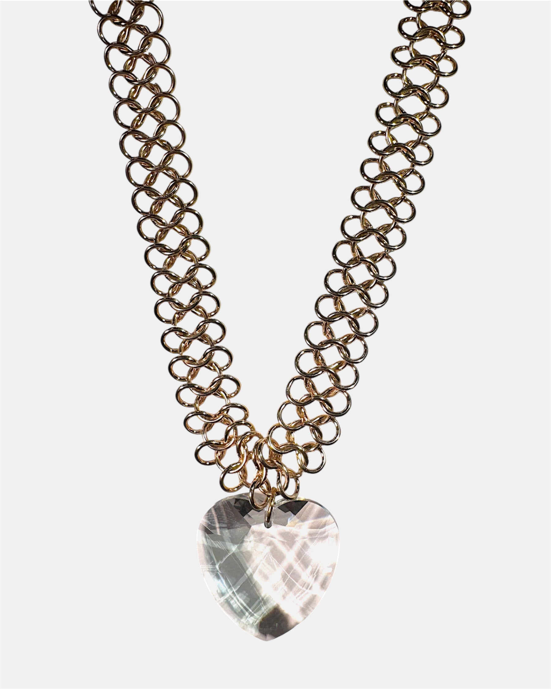 Gold chain necklace with a glass heart pendant
