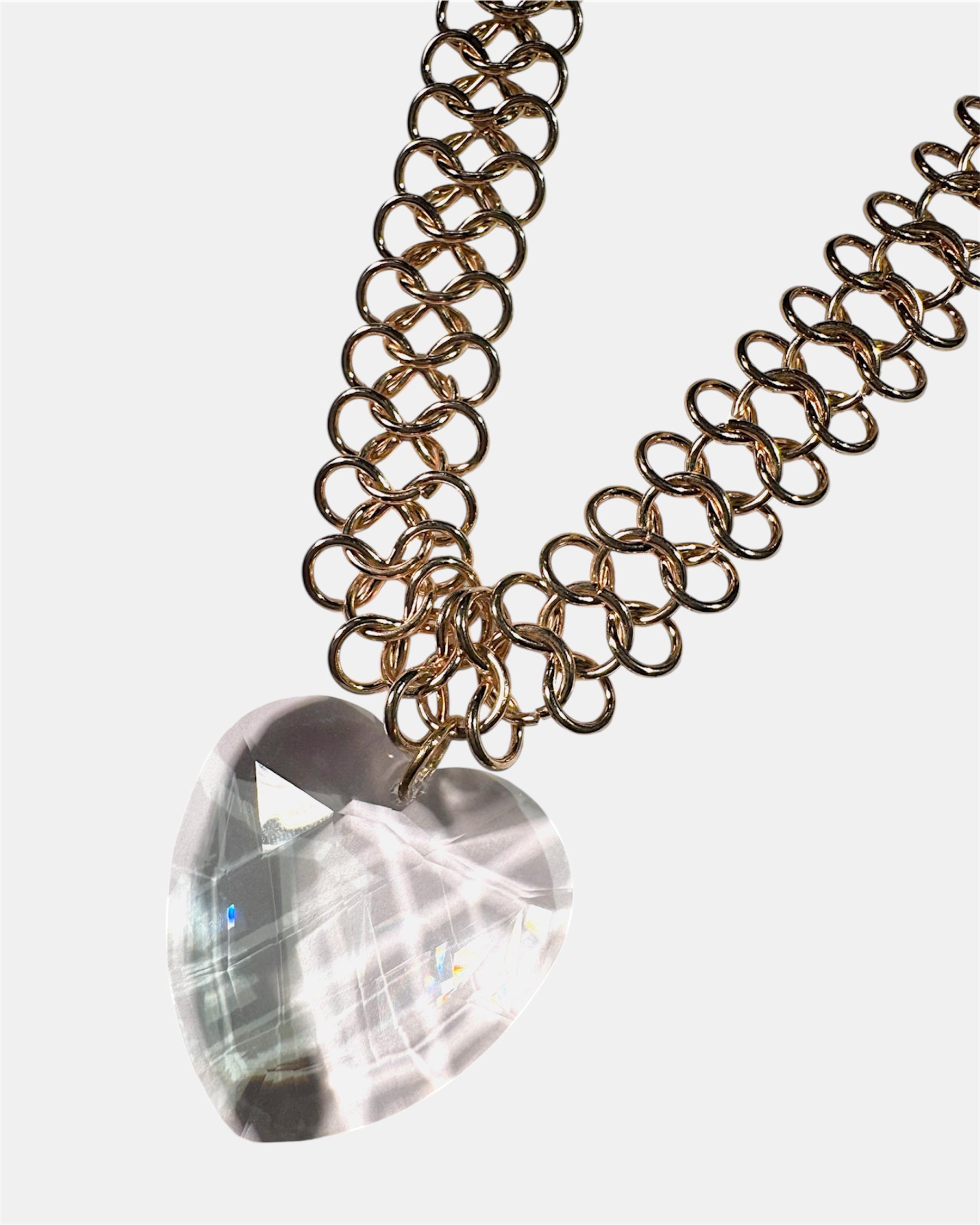 Gold chain necklace with a glass heart pendant