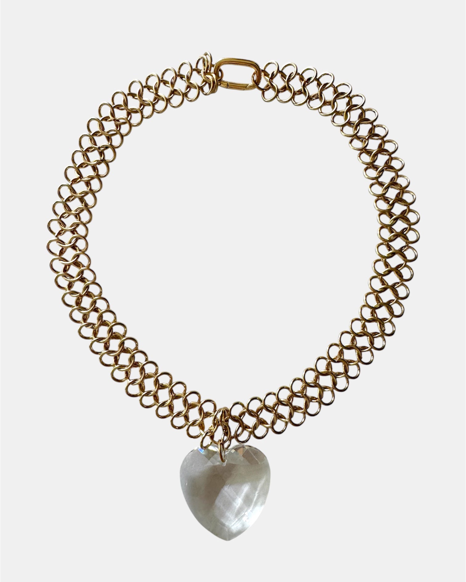 Gold chain necklace with a glass heart pendant