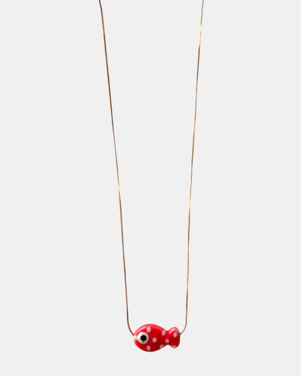 Gold chain necklace with a red fish charm