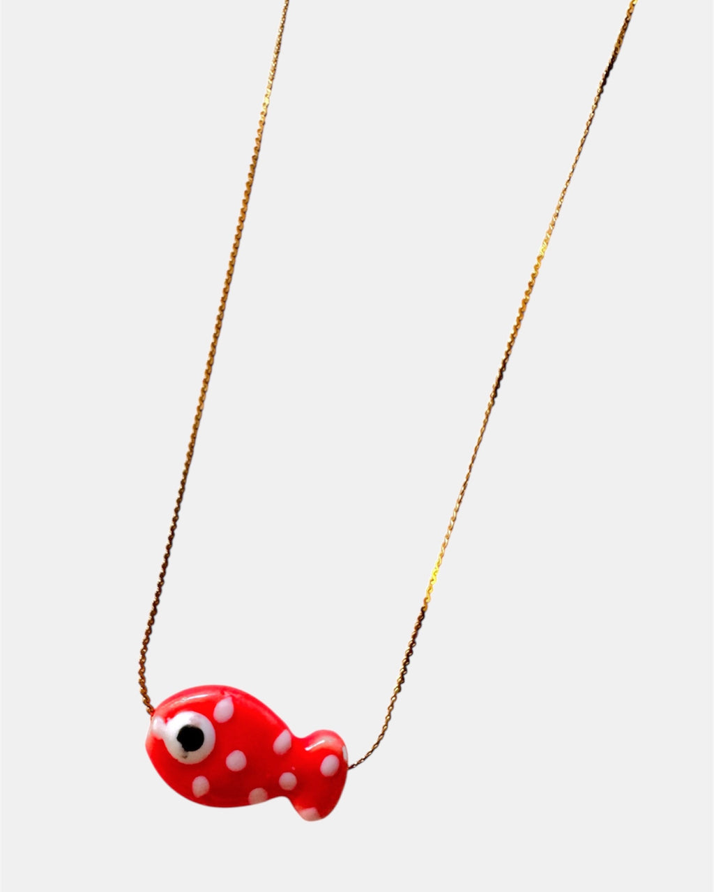 Gold chain necklace with a red fish charm