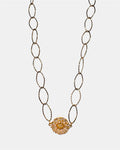 Gold chain necklace with a round charm
