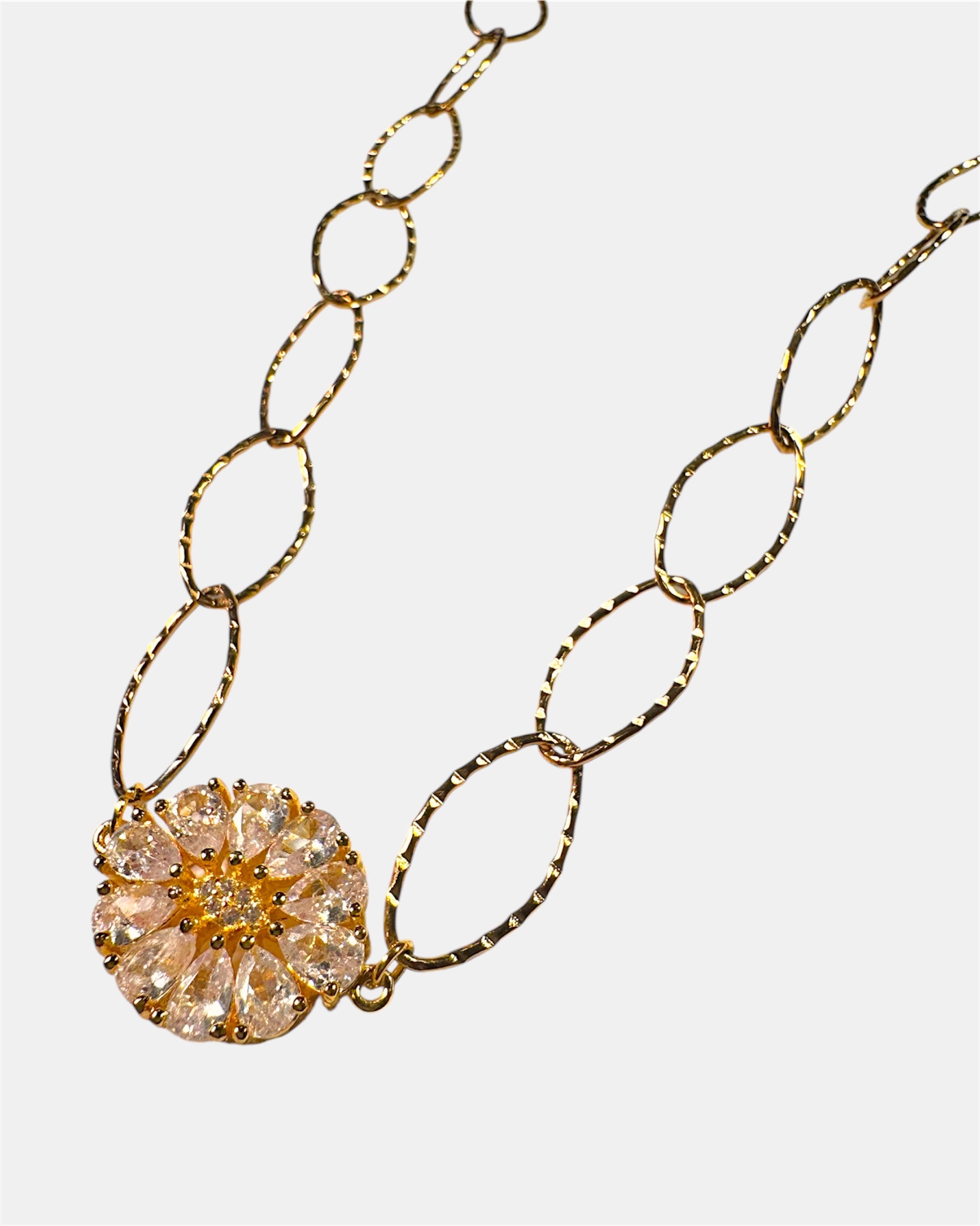 Gold chain necklace with a round charm