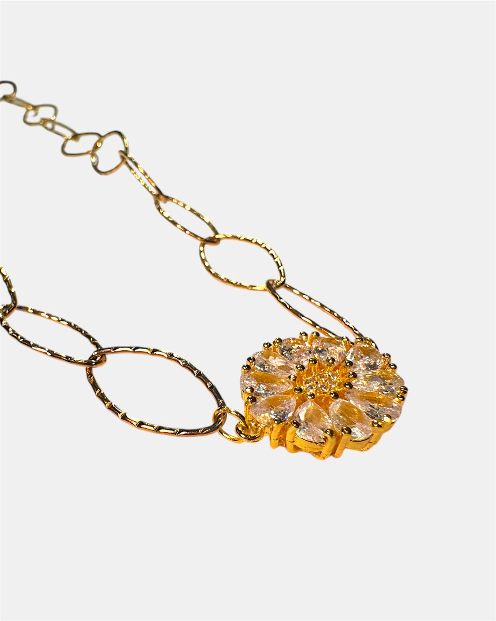 Gold chain necklace with a round charm
