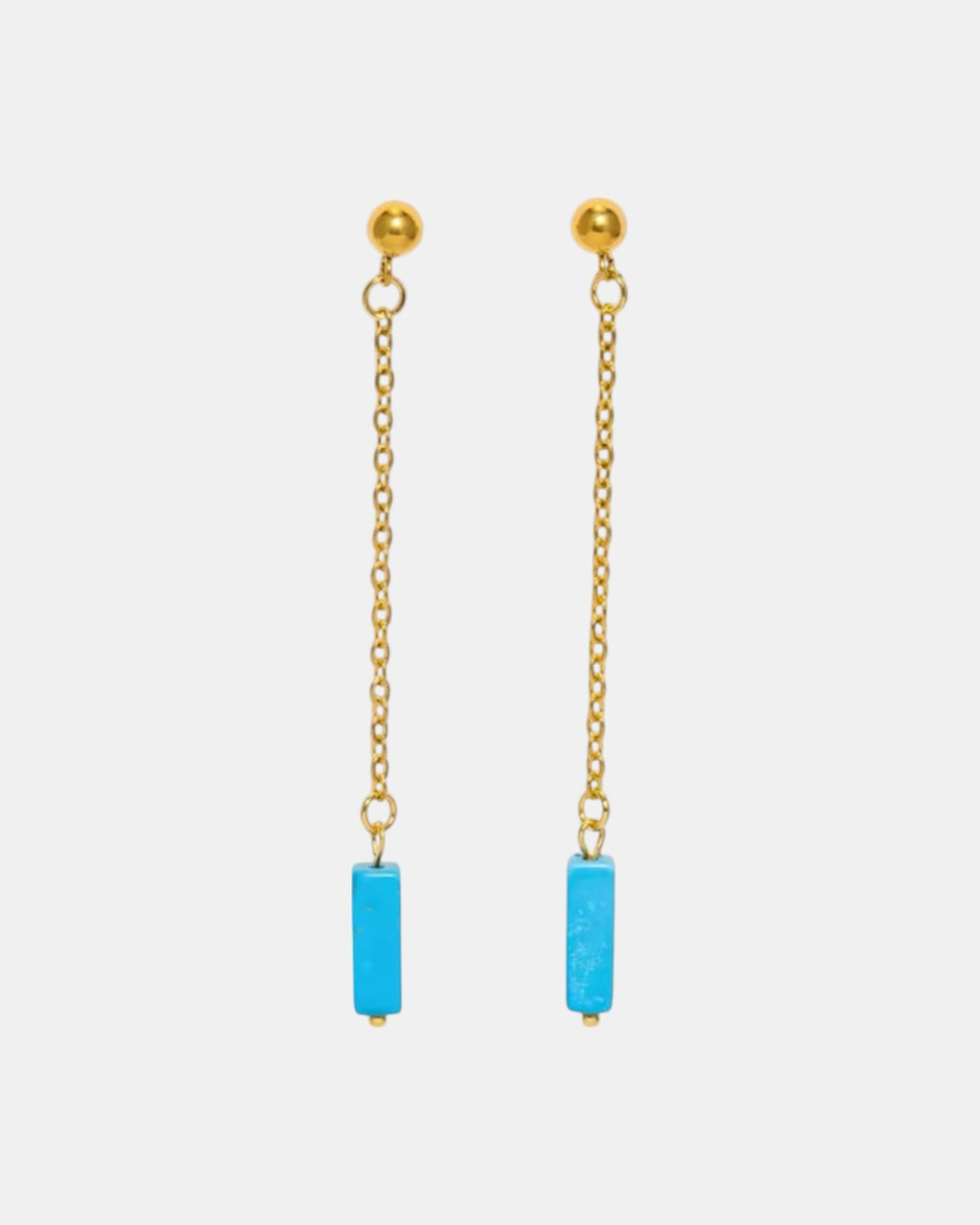 Gold dangle earrings with a blue stone