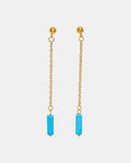 Gold dangle earrings with a blue stone